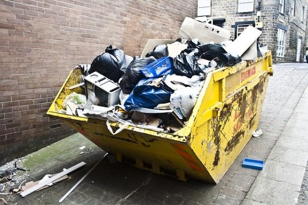 a yellow dumpster overfilled with e-waste that could be recycled, e-waste facts 2020