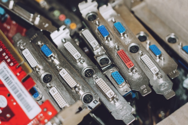 metal graphic cards stacked in a bin before going through e waste disposal